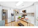 Updated kitchen featuring stainless steel appliances and wood-look floors at 9149 Washam Potts Rd, Cornelius, NC 28031