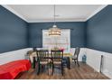 Bright dining room with a table and chairs, hardwood floors and blue walls at 98 Poplar Woods Dr, Concord, NC 28027