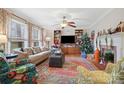 Cozy living room with a fireplace, built-in shelves, and bright windows at 1008 Candlewood Ln, Rock Hill, SC 29730