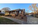 Side view of brick ranch home with driveway and landscaping at 1308 Princeton Ave, Gastonia, NC 28054