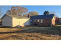 Rear view of home showcasing detached garage and yard at 1308 Princeton Ave, Gastonia, NC 28054