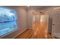 Bright living room showcases hardwood floors, neutral paint, ample windows and modern ceiling fan at 1308 Princeton Ave, Gastonia, NC 28054