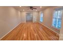 Spacious living room featuring gleaming hardwood floors, neutral paint and bright windows at 1308 Princeton Ave, Gastonia, NC 28054