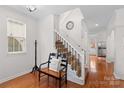 Bright entryway with hardwood floors, staircase, and coat rack at 19830 Madison Village Dr # 65, Cornelius, NC 28031