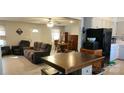 Open living and dining area with L-shaped sofa and wood table at 2544 Harmony Rd, Rock Hill, SC 29730