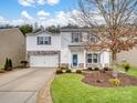 Two-story house with attached garage and landscaped yard at 2565 Meadow Crossing Dr, Dallas, NC 28034