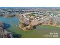 An aerial view of townhomes surrounded by water and lush greenery at 4146 La Crema Dr, Charlotte, NC 28214