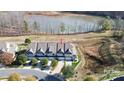 Townhomes near lake feature sidewalks, attached garages, and community landscaping at 4146 La Crema Dr, Charlotte, NC 28214
