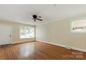Spacious living room with hardwood floors, ceiling fan, and plenty of natural light at 549 Spring Sw St, Concord, NC 28025