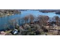 Stunning aerial view of lakefront homes nestled among lush greenery and serene waters at 8046 Lucky Creek Ln, Denver, NC 28037