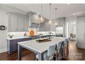 Modern kitchen with gray cabinets, quartz countertops, and stainless steel appliances at 1117 Churchill Commons Dr, Charlotte, NC 28211