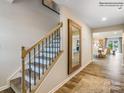 Elegant wooden staircase with wrought iron spindles and a large mirror in the hallway at 2509 Trollinger Dr, Catawba, NC 28609