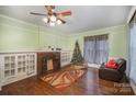 Living room with hardwood floors, fireplace, and built-in shelving at 302 Charlotte St, York, SC 29745