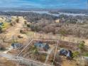 Aerial view of a house on a large lot near a golf course and lake, with mature trees surrounding the property at 1115 Stony Point Rd, Kings Mountain, NC 28086