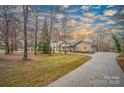Beautiful brick home with a circular driveway, mature trees, and well-maintained landscaping in a serene setting at 1115 Stony Point Rd, Kings Mountain, NC 28086