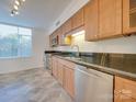 Modern kitchen features stainless steel appliances, granite countertops, and bright natural light at 1300 Queens Rd # 303, Charlotte, NC 28207