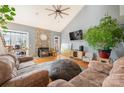 Inviting living room with stone fireplace, vaulted ceiling, wood floors, and cozy seating, creating a warm and stylish ambiance at 15215 Timberview Ln, Huntersville, NC 28078