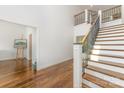 Elegant foyer showcasing a staircase with iron railing and hardwood flooring at 174 Bellingshire Dr, Mt Ulla, NC 28125