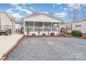 Single story home with screened porch and gravel driveway at 108 Elm St, New London, NC 28127