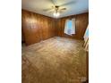 Living room featuring wood paneled walls and carpet at 112 Adcock St, Belmont, NC 28012