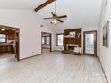 Bright living room with a brick fireplace, beamed ceiling, and wood-look flooring at 1805 Tufnell Ct, Charlotte, NC 28262