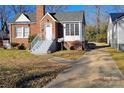 Brick ranch home with steps leading to the front entrance and a spacious yard at 602 W Graham St, Shelby, NC 28150