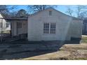 Side view of a white sided house with a small patio and driveway at 602 W Graham St, Shelby, NC 28150