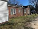 Brick house exterior with a side yard and mature trees at 602 W Graham St, Shelby, NC 28150