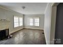 Bright living room featuring hardwood floors and a fireplace at 602 W Graham St, Shelby, NC 28150