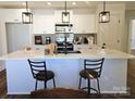 Bright kitchen showcasing a large quartz countertop island with seating and stylish pendant lights at 625 Charles St, Rockwell, NC 28138