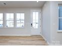 Bright living room with lots of natural light, wood floors, and a fresh, neutral color scheme at 8912 Connover Hall Ave, Charlotte, NC 28215