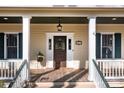 Inviting front porch with decorative stained glass door, sidelights, and view of address at 917 Patrick Johnston Ln, Davidson, NC 28036