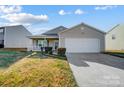 Charming ranch home with a two-car garage and manicured lawn at 9315 Ames Hollow Rd, Charlotte, NC 28216