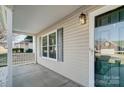 Inviting front porch with gray siding and a glass front door at 9315 Ames Hollow Rd, Charlotte, NC 28216