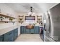 Modern kitchen featuring teal cabinets, copper sink, and quartz countertops at 9638 Pleasant View Ln, Mint Hill, NC 28227