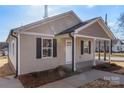 Newly built tan house with a front porch and landscaping at 17 N Arlington St, Salisbury, NC 28144