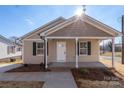 Newly built tan house with a front porch at 17 N Arlington St, Salisbury, NC 28144