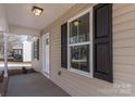 Covered porch with tan siding and black shutters at 17 N Arlington St, Salisbury, NC 28144