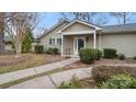 Inviting home with a landscaped front yard, sidewalk, and a charming covered entryway with a vibrant green door at 2712 New Hamlin Way, Charlotte, NC 28210