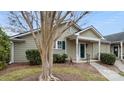Quaint home featuring a well-kept yard and a welcoming covered entrance with a bright green front door at 2712 New Hamlin Way, Charlotte, NC 28210