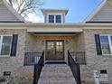 Front entry of charming brick home with double doors and black railings at 496 19Th Avenue Nw Cir, Hickory, NC 28601