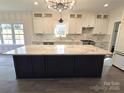Spacious kitchen boasts a large island with white cabinets and marble countertops at 496 19Th Avenue Nw Cir, Hickory, NC 28601