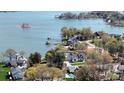 Expansive aerial view of lakeside home surrounded by lush greenery and waterfront access at 5056 Bridge Way, Denver, NC 28037