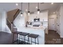 Modern kitchen with an island, stainless steel appliances, sleek countertops, and stylish pendant lighting at 5680 Clear Creek Ln, Charlotte, NC 28215