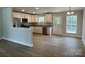 Bright and open kitchen featuring stainless steel appliances, white cabinets, and a wood floor at 702 Park Ave, Salisbury, NC 28144