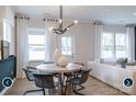 Dining area features modern lighting, stylish furniture, and an open floor plan at 14042 Aikenwood Dr, Charlotte, NC 28278