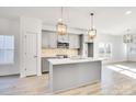 Modern kitchen with gray cabinets, quartz countertops, and an island at 1535 Solitude Ct, Kannapolis, NC 28081