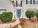 Welcoming front entrance with blue door and landscaping at 17628 Cambridge Grove Dr, Huntersville, NC 28078