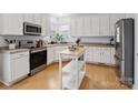 Bright kitchen featuring white cabinets, stainless steel appliances and natural light at 17628 Cambridge Grove Dr, Huntersville, NC 28078