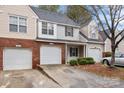 Townhouse with brick and siding, two-car garage, and curb appeal at 2022 University Heights Ln, Charlotte, NC 28213